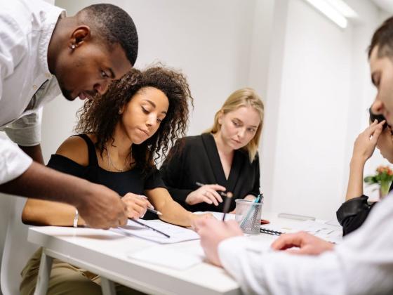 Group of employees reviewing document